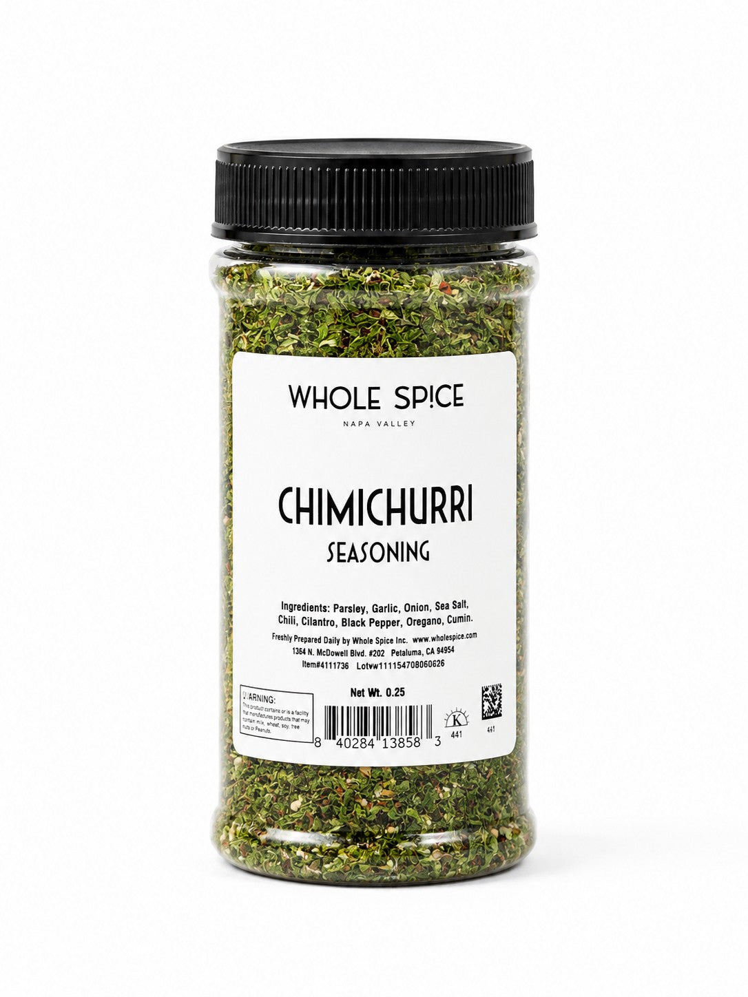 A clear plastic jar of Whole Spice Inc. Chimichurri Seasoning with a black lid. The white label displays the ingredients and features bold text reading “CHIMICHURRI SEASONING.” Ideal for adding vibrant flavor to grilled steak or for making your own authentic chimichurri sauce.