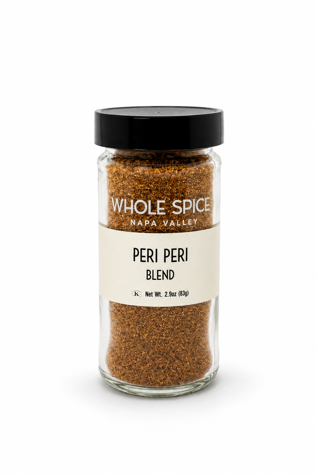 A glass jar labeled Whole Spice Inc. Peri Peri Blend, featuring a reddish-brown spice mix with African birds-eye pepper, topped with a black lid and displayed against a plain white background.