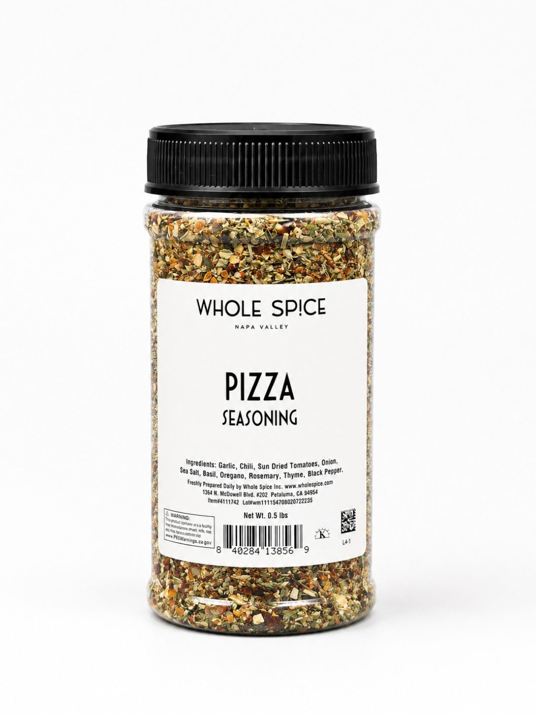 A clear plastic jar labeled Pizza Seasoning from Whole Spice Inc., filled with a vibrant mix of herbs and spices such as garlic, chili, sun dried tomatoes, onion, basil, and oregano—ideal for boosting the flavor of pizza sauce or enriching pasta dishes.