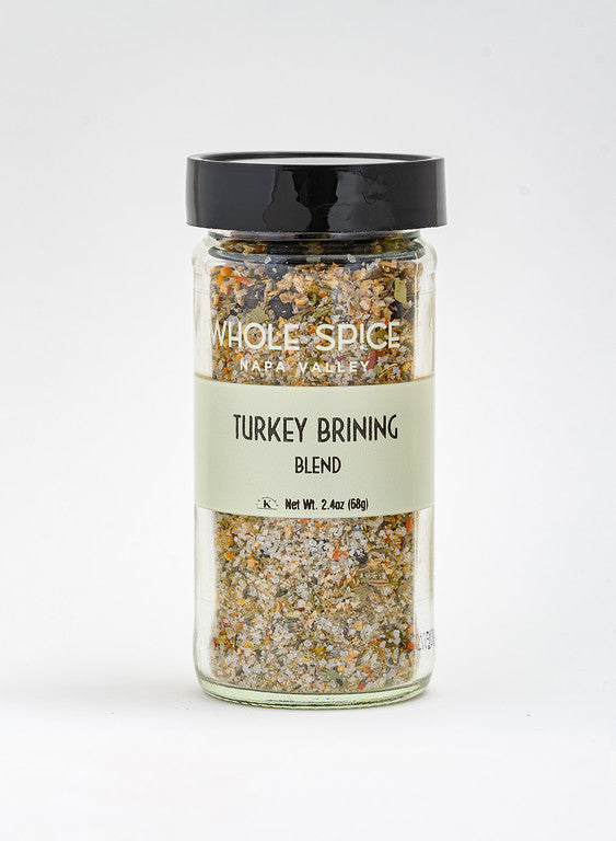A glass jar with a black lid holds Whole Spice Inc. Turkey Brining Blend, a coarse seasoning ideal for turkey brine. The jar’s pale green label shows the product name and a net weight of 2.4 oz (68g).