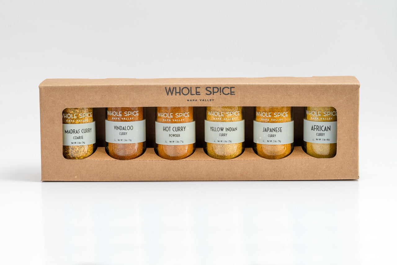 The Whole Spice Curry Gift Set by Whole Spice Inc. includes six glass jars—Madras Curry, Vindaloo, Hot Curry, Yellow Indian, Japanese, and African—in a sturdy holder, perfect for discovering global curry flavors.