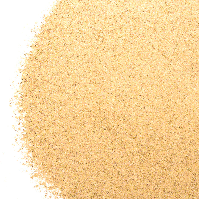 A close-up shows a pile of fine, light brown Whole Spice Inc. Portobello Mushroom Powder - 1 oz Bulk spread on a white background, mainly concentrated on the right and lightly scattered outward.