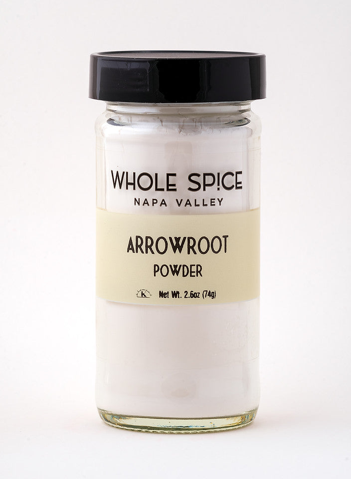 A 2.6 oz (74g) clear glass jar with a black lid labeled Whole Spice Inc. Arrowroot Powder, a gluten-free thickener, contains white powder and is shown against a plain white background.