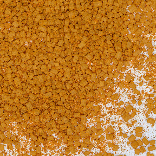 A pile of orange food items sprinkled with Whole Spice Inc. Cinnamon Sugar, giving off the warm aroma reminiscent of cinnamon toast.