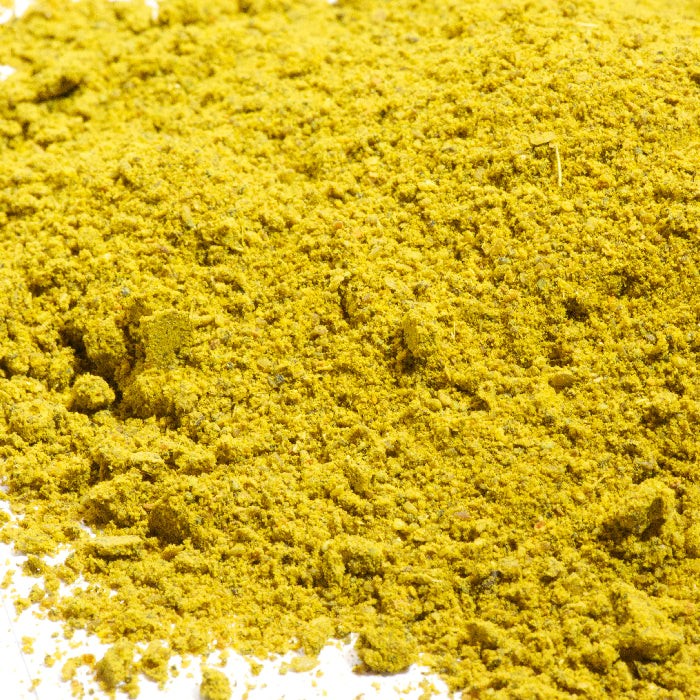 A close-up of Whole Spice Inc. African Curry Powder, highlighting its fine, crumbly texture and vibrant yellow hue—ideal for adding authentic curry flavor to African or Indian dishes.