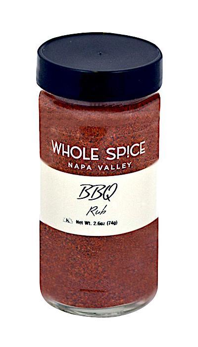 A clear glass jar with a black lid holds Whole Spice Inc. BBQ Rub, a flavorful grilling seasoning. The white label features the BBQ Rub name and a net weight of 2.6 oz (74g).