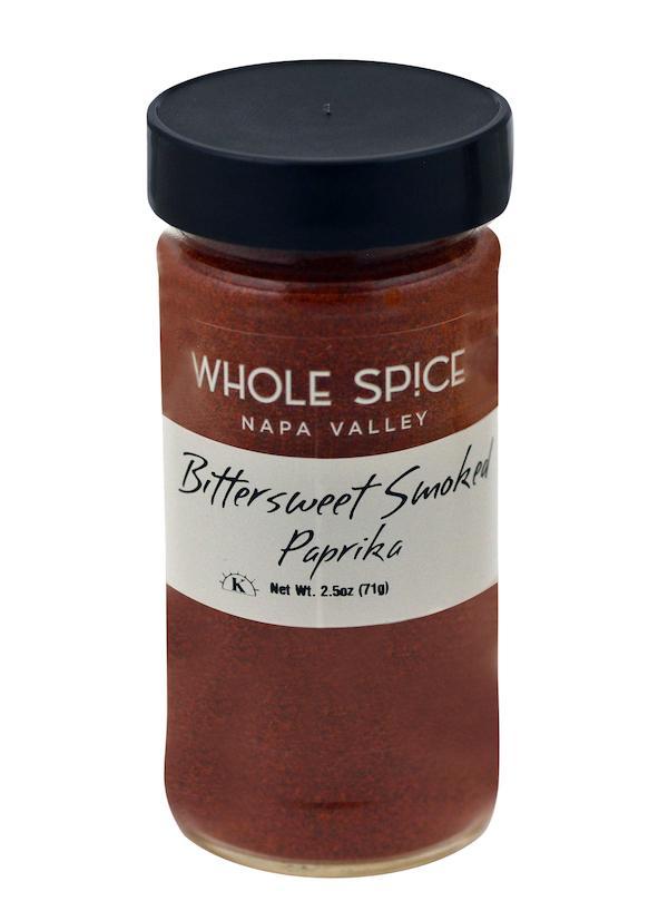 A 2.5 oz (71 g) glass jar of Whole Spice Inc. Bittersweet Smoked Paprika features a black lid, white label, and contains reddish-brown Spanish paprika blend.
