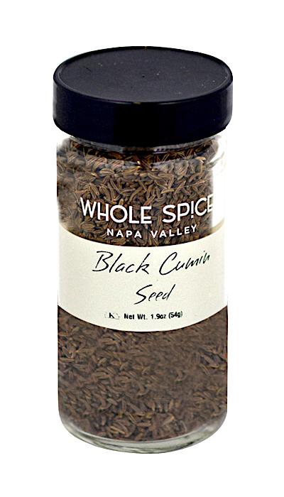 A glass jar of Whole Spice Inc. Black Cumin Seed with a black lid contains 1.9 oz (54g) of small brown seeds, commonly used in Indian cuisine. The label reads "Black Cumin Seed.