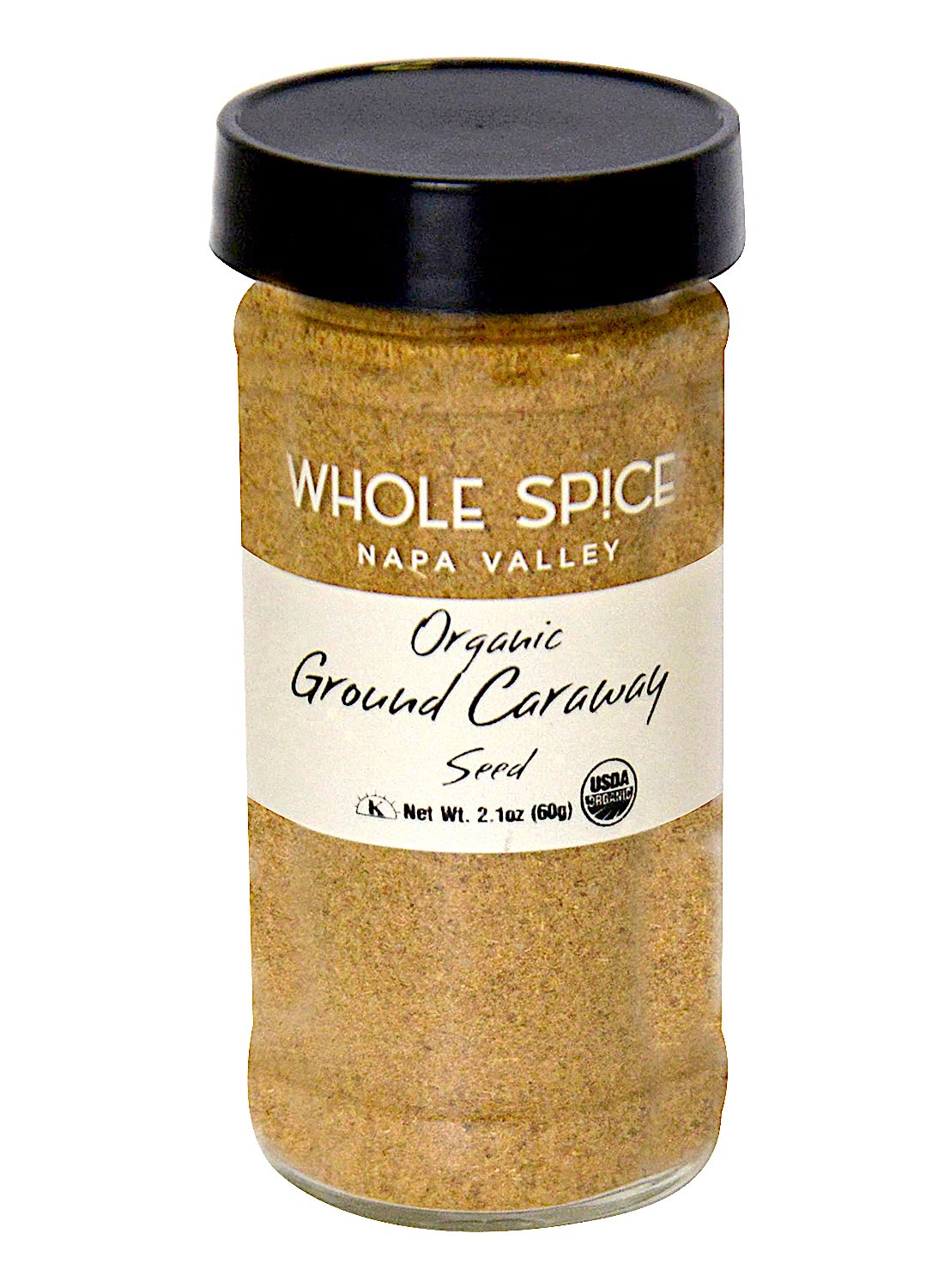 A 2.1 oz (60g) glass jar with a black lid labeled “Whole Spice Inc. Caraway Seed Ground Organic,” contains finely ground organic caraway seed and displays the USDA organic seal.