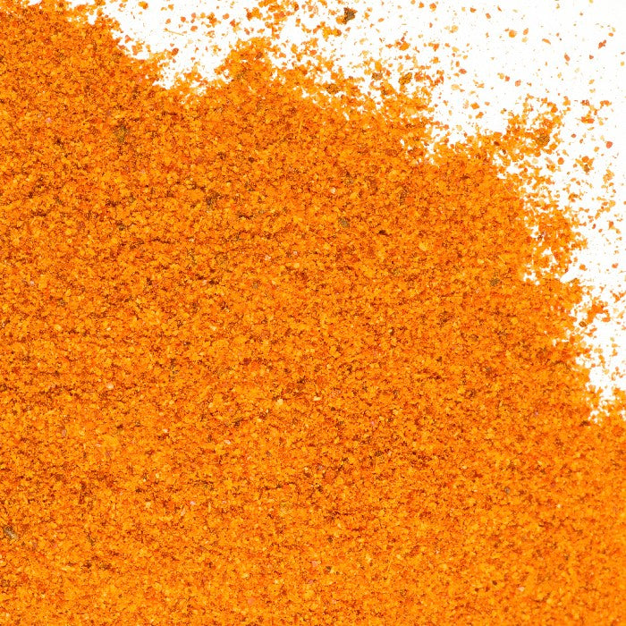 Charmoula Seasoning by Whole Spice Inc. is a vibrant orange powder, inspired by Moroccan flavors, ready to elevate your dishes.