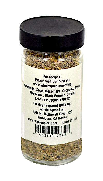 A clear spice jar with a black lid contains Whole Spice Inc.’s Chicken Stuffing Seasoning, an aromatic blend of sage, rosemary, oregano, and thyme—perfect for roast chicken. The label includes the brand and website details.