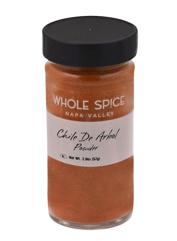A jar of Chili De Arbol Powder by Whole Spice Inc., crafted from authentic Mexican chili peppers for a vibrant orange color.