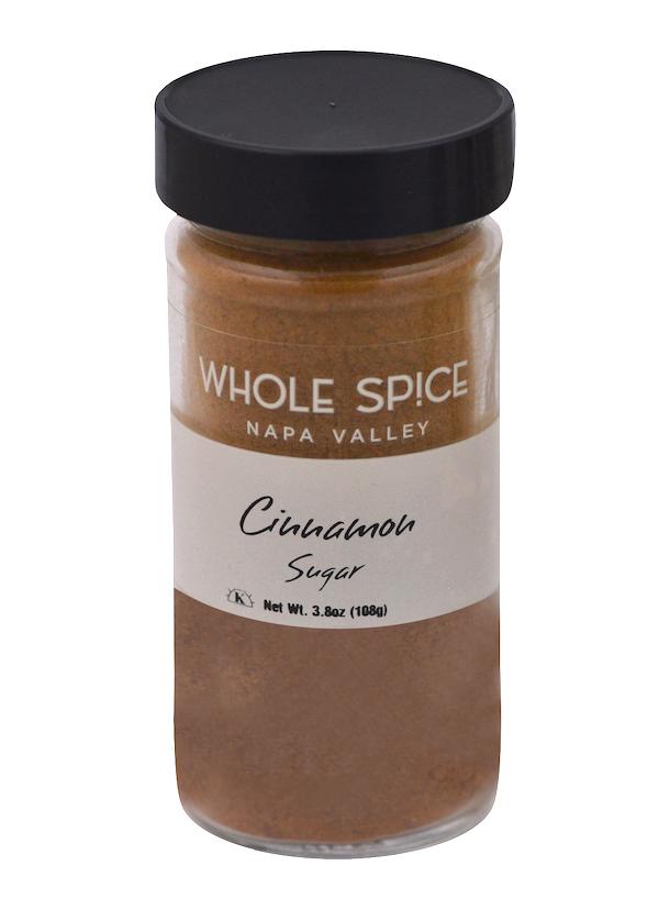 A 3.8 oz (108g) glass jar of Whole Spice Inc. Cinnamon Sugar with a black lid blends Saigon cinnamon and demerara sugar, perfect for making irresistible cinnamon toast.