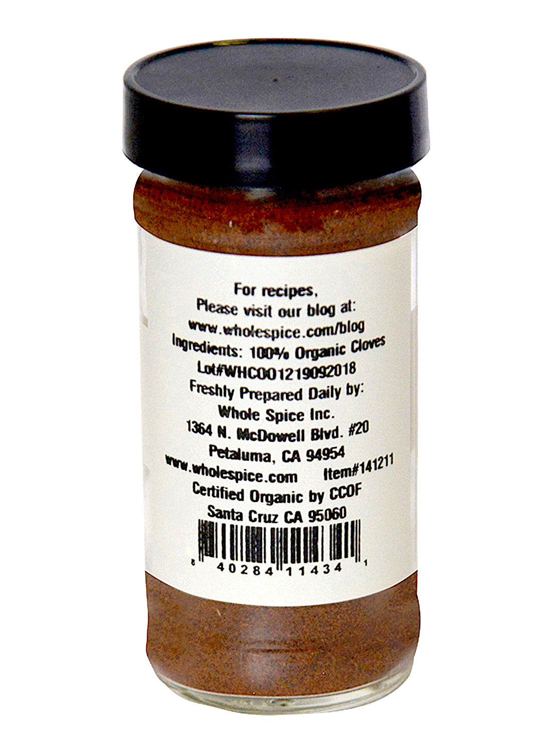 A glass jar of Cloves Ground Organic by Whole Spice Inc., featuring a white label with ingredient info, company address, website, barcode, and certification details all printed in black text.