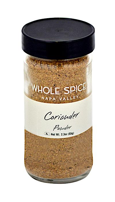 A 2.3 oz (65g) glass jar of Coriander Powder by Whole Spice Inc., with a black lid. Ideal for Thai curries or as a tasty addition to pickling spices.