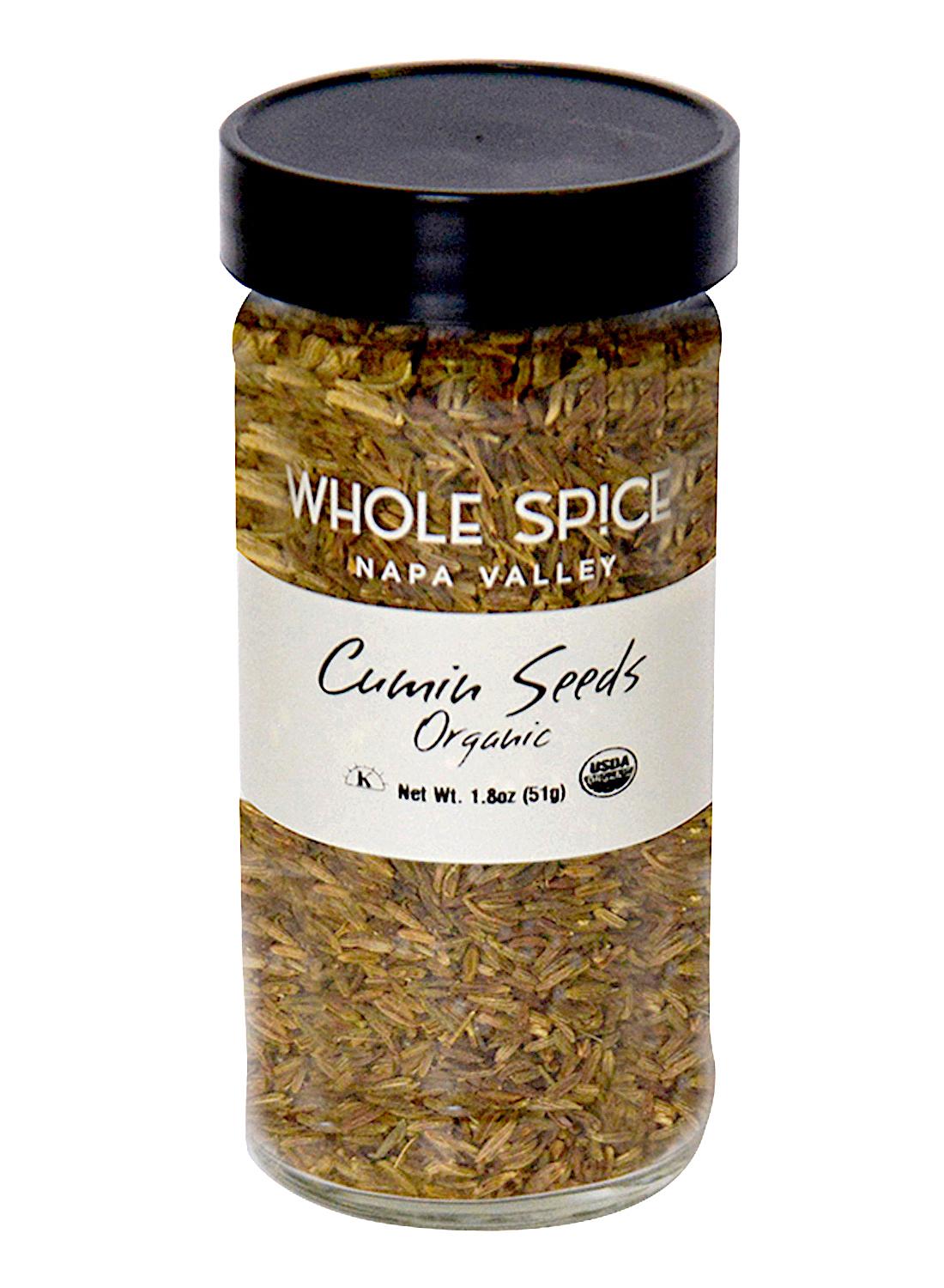 A jar of Whole Spice Inc. Cumin Seeds Organic with a black lid.