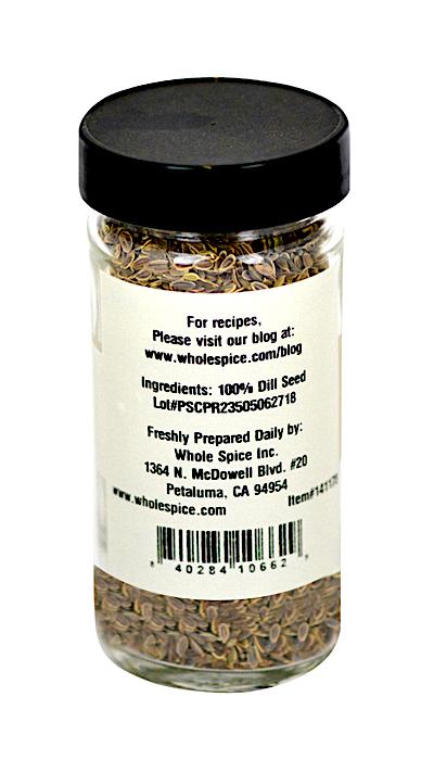 A clear glass jar with a black lid contains Whole Spice Inc. Dill Seeds, valued for digestion. The white back label displays ingredients, brand details, an address, and a barcode at the bottom.