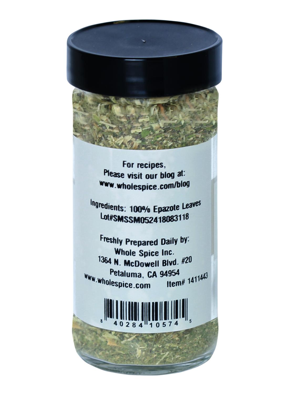 A clear spice jar with a black lid contains Whole Spice Inc. Epazote Leaves Crushed, ideal for herbal teas. The back label lists ingredients, website, lot number, and preparation info from Whole Spice Inc., Petaluma, CA.