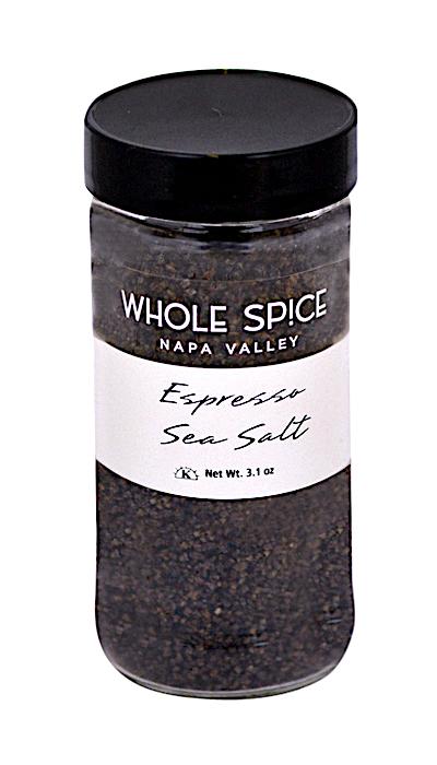 A clear 3.1 oz jar of Espresso Sea Salt by Whole Spice Inc., featuring a black lid and dark brown granules, perfect for steak rubs or adding bold flavor to dishes.