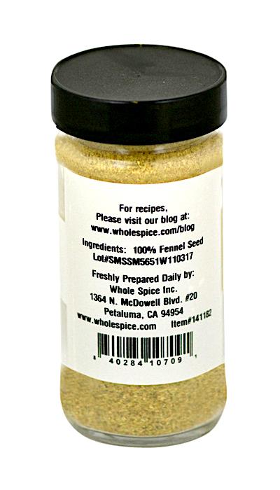A clear spice jar with a black lid contains Whole Spice Inc. Fennel Powder, made from 100% fennel seed with an anise-like flavor. The label features a website, address, and barcode.