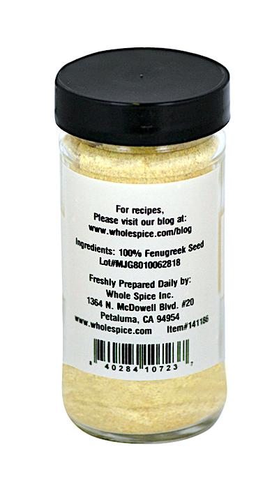 A clear jar with a black lid holds Whole Spice Inc. Fenugreek Powder, made from 100% fenugreek seeds. The label includes the brand’s address, website, and a lot number—perfect for spice blends.