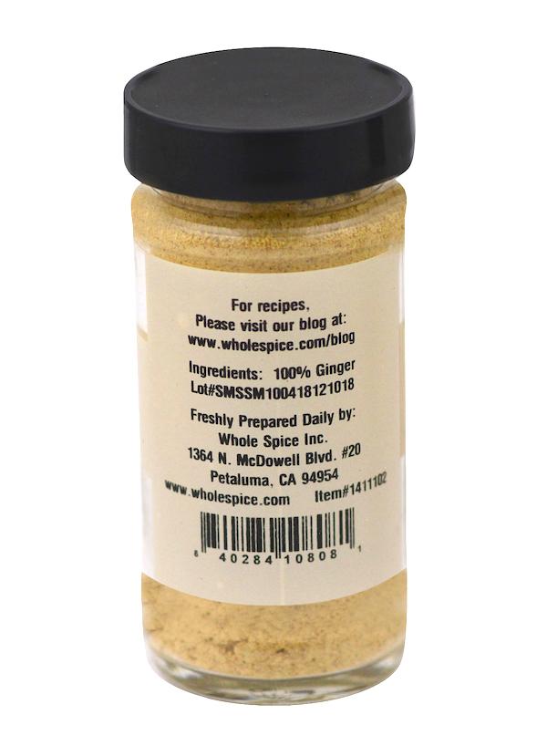 A clear spice jar with a black lid, labeled “Ginger Powder” by Whole Spice Inc. The label notes it’s 100% ginger powder, includes preparation info, a website link, barcode, and the company address in Petaluma, CA.