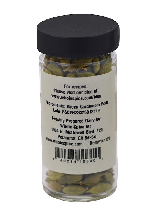 A clear glass jar with a black lid, filled with Green Cardamom Pods from Whole Spice Inc. The label displays ingredients, company info, website details, and a barcode at the bottom—a classic pick for Indian spiced tea.