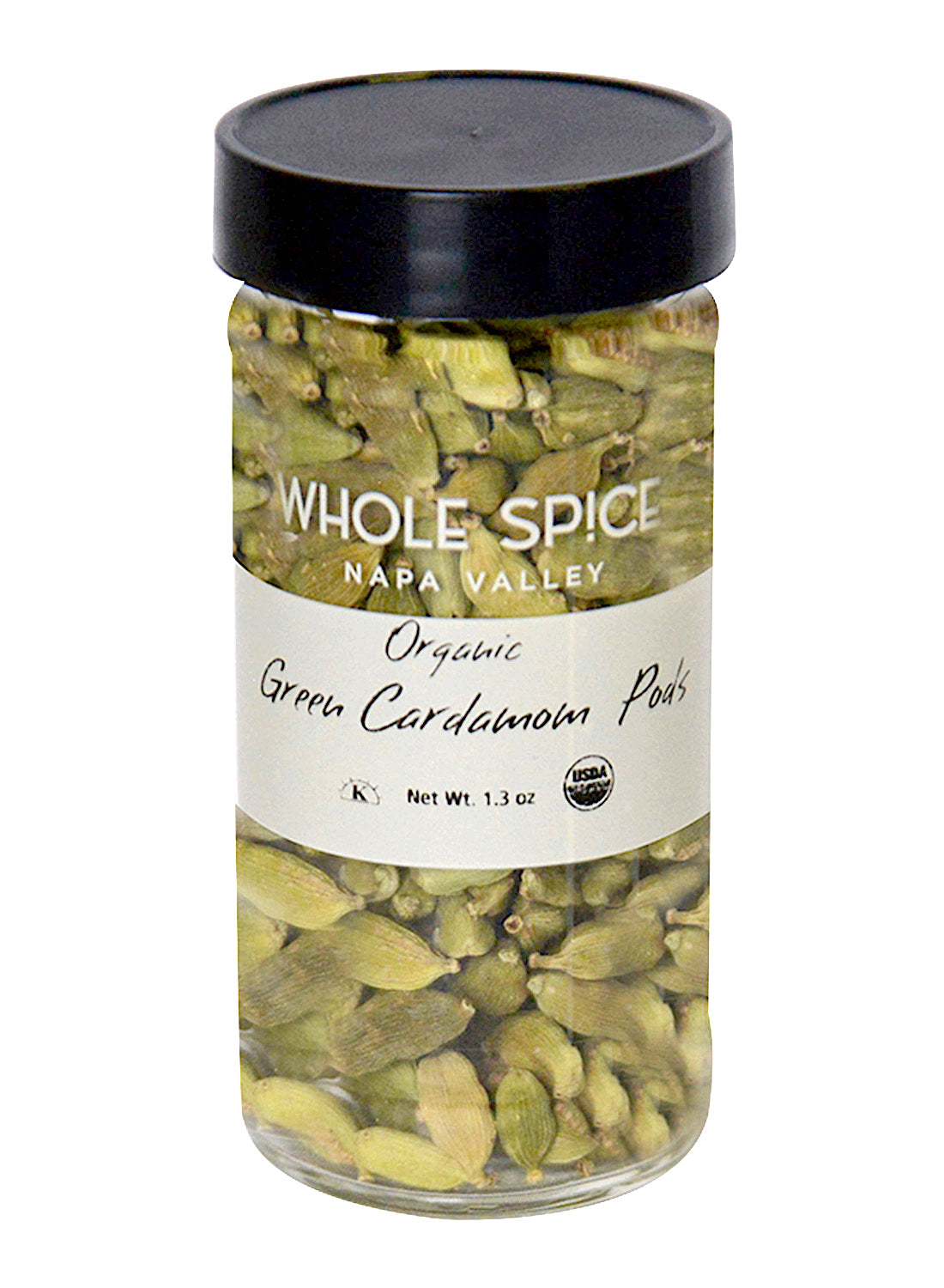 A clear glass jar with a black lid, labeled “Whole Spice Inc. Green Cardamom Pods Organic,” holds premium cardamom ideal for baking. The 1.3 oz jar features organic certification logos for quality assurance.