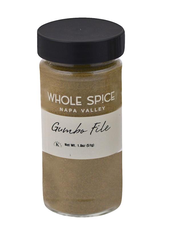 A clear glass jar with a black lid labeled "Gumbo Filé" by Whole Spice Inc., containing 1.8 oz (51g) of greenish-brown powder—a classic Creole and Cajun thickener.