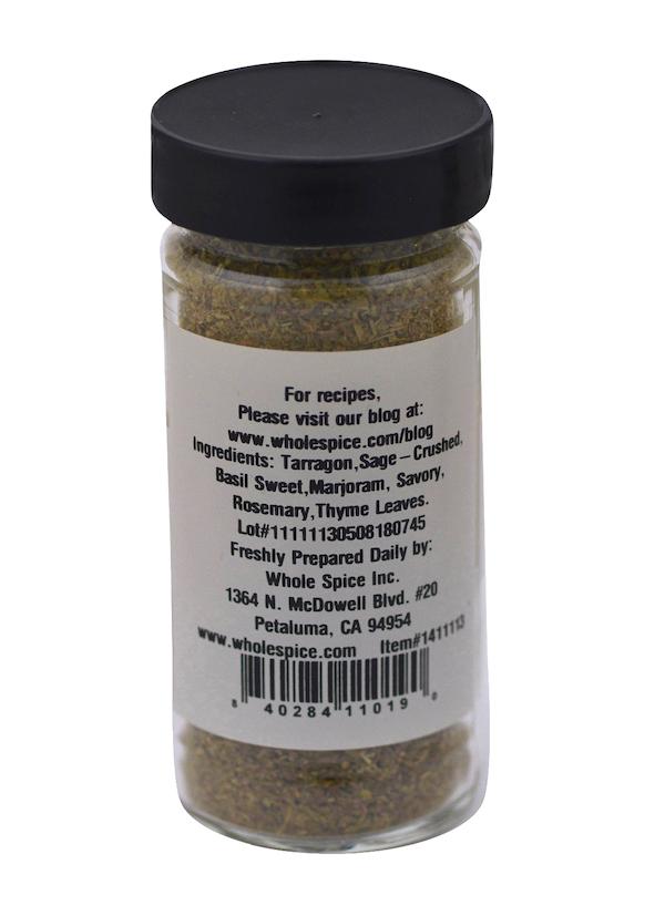 A clear spice jar with a black lid from Whole Spice Inc., labeled "Italian Seasoning Small Cut" and listing tarragon, sage, basil, marjoram, savory, rosemary, and thyme—perfect for pizza or pasta. Label includes contact info.