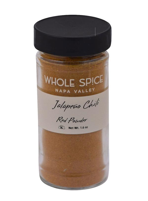 A 1.6 oz glass jar of Whole Spice Inc. Jalapeño Red Chili Powder with a black lid, labeled accordingly, containing reddish-brown dried red chili pepper powder.