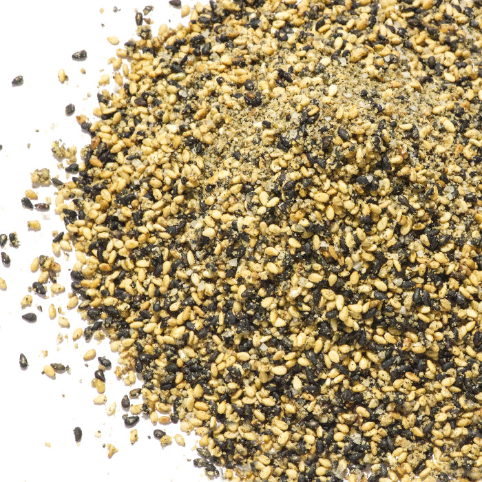 A close-up of Whole Spice Inc. Japanese Gomashio—a blend of black and white sesame seeds—on a white background, perfect for making roasted sesame salt, a classic macrobiotic seasoning.