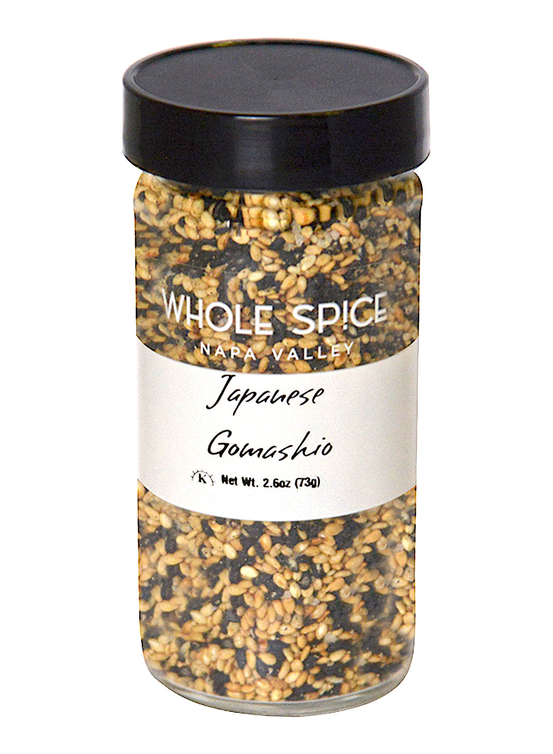 A clear jar of Whole Spice Inc. Japanese Gomashio contains a macrobiotic blend of black and white sesame seeds. It features a black lid and a white label with black text.