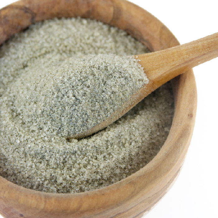 Whole Spice Inc. Lavender Sugar, a blend of coarse, greyish-green salt in a wooden bowl with a matching spoon—ideal for sprinkling on lavender cookies or mixing into homemade lavender treats.