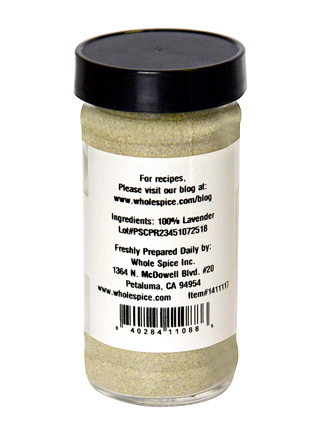 A glass jar of Whole Spice Inc. Lavender Powder with a black lid features a back label stating "100% culinary lavender" and includes the brand’s website and address in Petaluma, California.