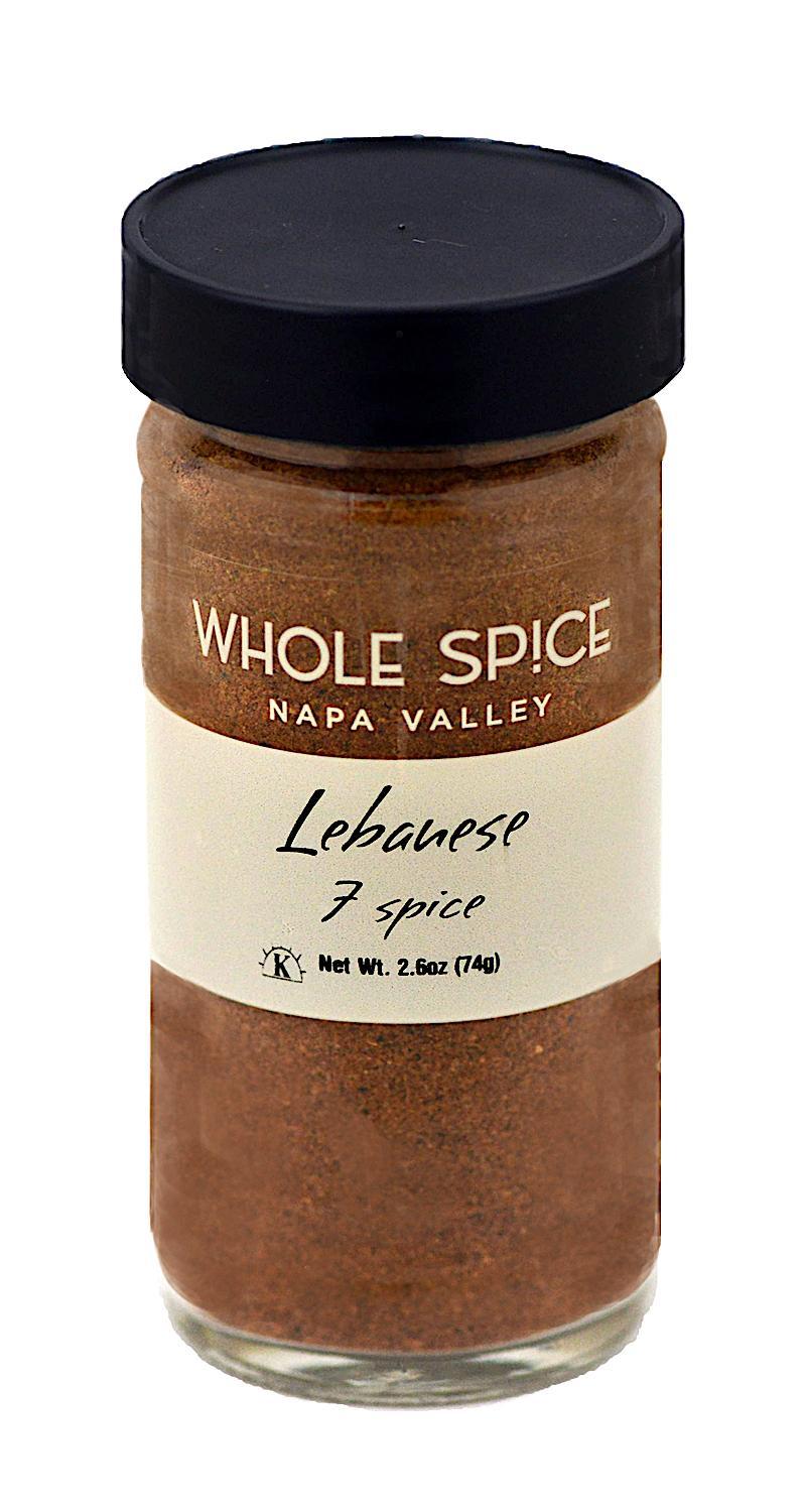 A 2.6 oz (74g) glass jar of Whole Spice Inc. Lebanese Seven Spice with a black lid, an aromatic blend ideal as a meat rub or for adding rich flavor to your favorite dishes.