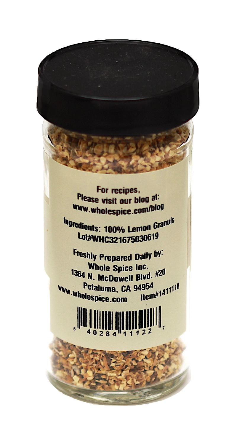 Whole Spice Inc. Lemon Peel Granules come in a glass jar with a black lid. The back label states 100% lemon granules, ideal for baking, and includes company contact info, website, and a barcode at the bottom.