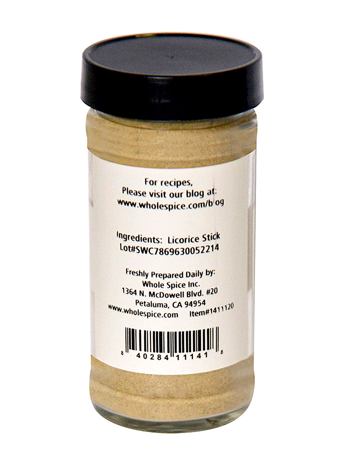A clear glass jar with a black lid contains light brown Licorice Stick Powder from Whole Spice Inc. A white label lists ingredients, lot number, company address, barcode, and website with recipes and contact details.