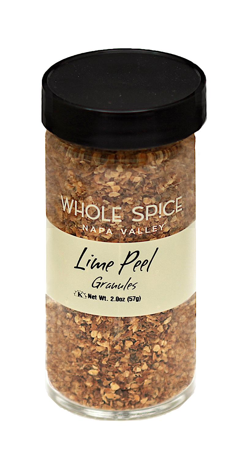 A clear glass jar with a black lid contains Whole Spice Inc. Lime Peel Granules, Net Wt. 2 oz (57g)—ideal for adding fresh lime zest flavor to your dishes.