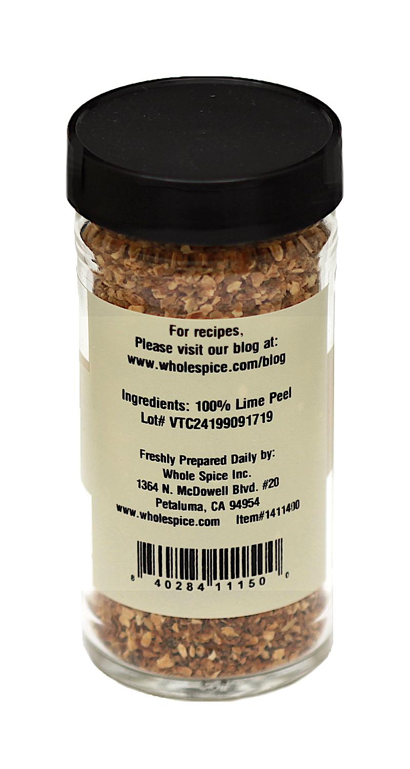 A clear spice jar by Whole Spice Inc., labeled “Lime Peel Granules” with a black lid. Contains dried lime peel granules—perfect for zesting up dishes. The label lists ingredients, a recipe blog link, contact info, and barcode.