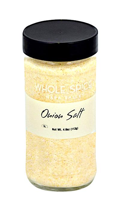 A clear glass jar with a black lid holds finely ground, light yellow Onion Salt by Whole Spice Inc. The label states “Onion Salt Net Wt. 4.0oz (113g).” This gourmet condiment is made with sea salt.