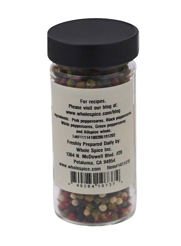 A clear jar labeled "Peppercorns Five Mix" by Whole Spice Inc. features a black lid and contains whole five pepper mix. The beige label has black text listing ingredients, company info, and a barcode.
