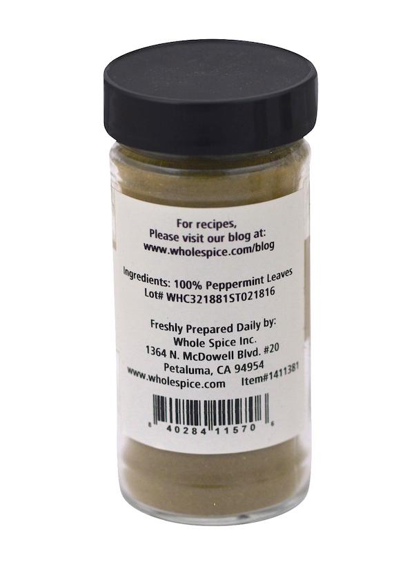 A clear jar with a black lid labeled "Peppermint Powder" from Whole Spice Inc. contains 100% peppermint leaves, ideal as a mint herb or seasoning. The label features distributor details, website, and barcode.
