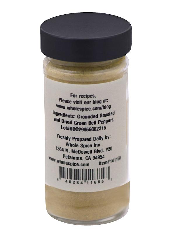 A clear spice jar with a black lid holds Whole Spice Inc. Roasted Green Bell Pepper Powder. The back label lists grounded roasted green bell peppers, details about the company, and a barcode at the bottom—an ideal paprika substitute.