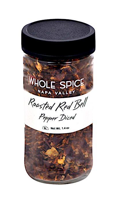 A clear spice jar from Whole Spice Inc. labeled Roasted Red Bell Pepper Diced with a black lid, filled with flavorful dried and roasted red bell peppers. Net weight: 1.4 oz.