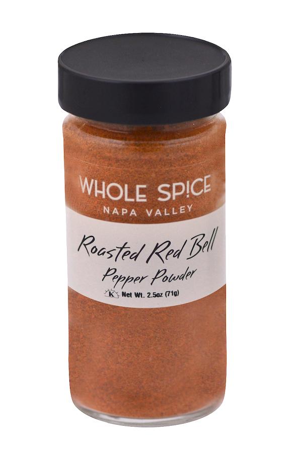 A clear jar with a black lid labeled Whole Spice Inc. Roasted Red Bell Pepper Powder holds fine red-orange powder. Net weight: 2.5 oz (71g).