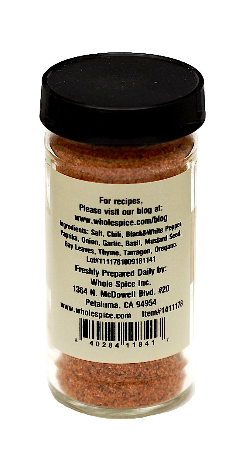 Whole Spice Inc. Salt Seasoning comes in a glass jar with a black lid and labeled with ingredients: salt, chili, black and white pepper, paprika, onion, garlic, basil, and other herbs—ideal for adding flavor to your favorite dishes.