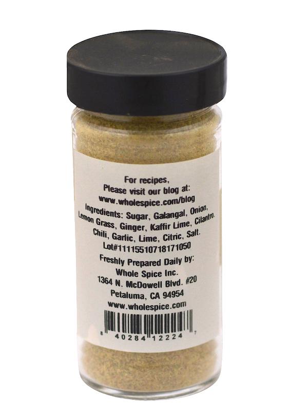 A clear spice jar with a black lid from Whole Spice Inc. displays a Sweet Thai Seasoning label listing Thai spices like sugar, galangal, onion, lemongrass seasoning, ginger, kaffir lime, chili, plus a barcode and contact info.