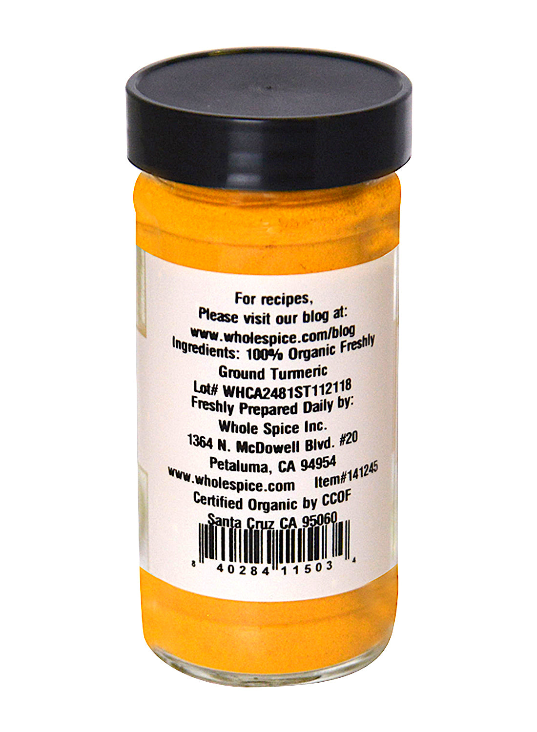Turmeric Powder Organic by Whole Spice Inc. comes in a clear glass jar with a black lid; the label shows ingredients, contact info for Whole Spice Inc., and a barcode at the bottom—perfect for enhancing Indian dishes.