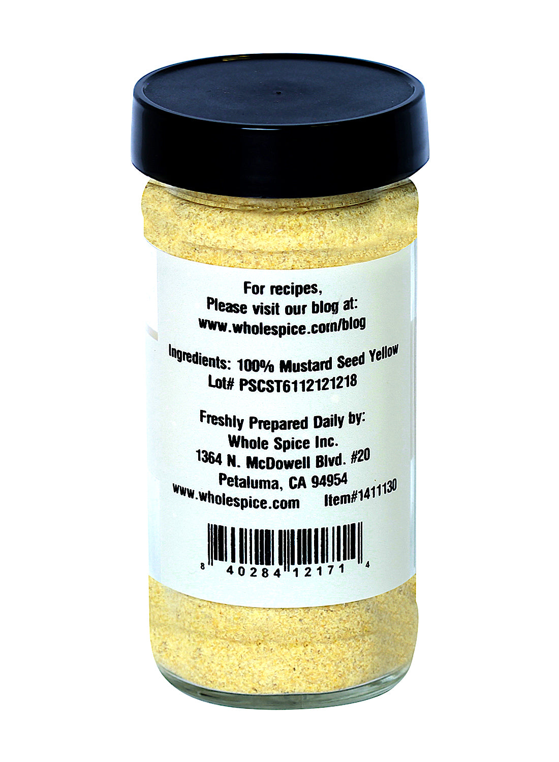 A clear jar with a black lid holds Whole Spice Inc. Yellow Mustard Seed Ground. The label shows ingredients, lot number, manufacturer info (Whole Spice Inc., Petaluma, CA), and a barcode at the bottom—perfect for culinary uses.